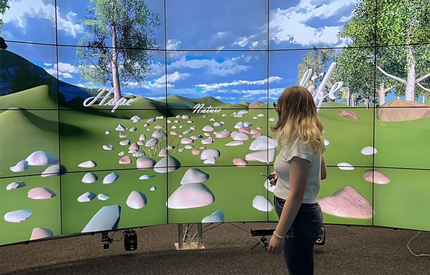 woman standing in front of screen holding VR handset